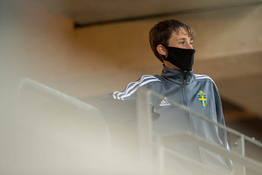 A ball boy with a face mask