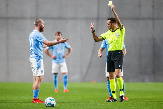 Jo Inge Berget of Malmö FF receives a yellow card
