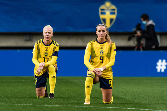 Caroline Seger and Kosovare Asllani of Sweden kneels in