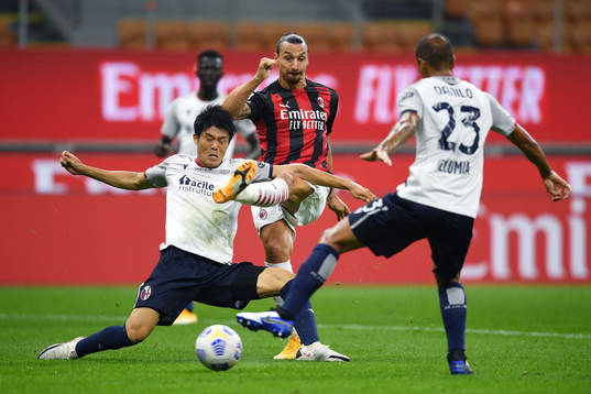 Zlatan Ibrahimovic of AC Milan against Takehiro Tomiyasu of