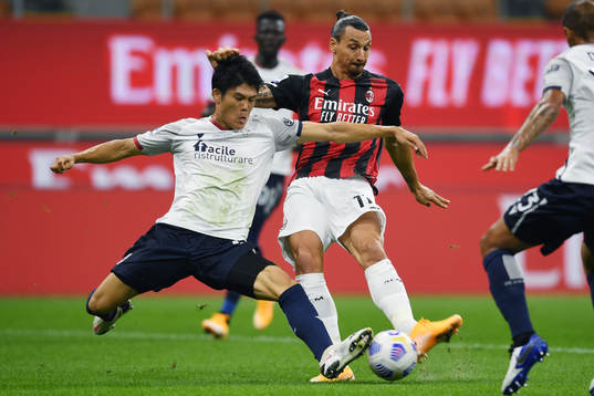 Zlatan Ibrahimovic of AC Milan against Takehiro Tomiyasu of