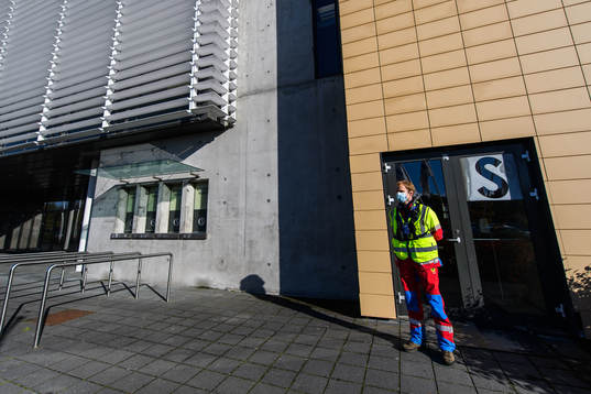 A steward outside Laugardalsvöllur stadium with a face