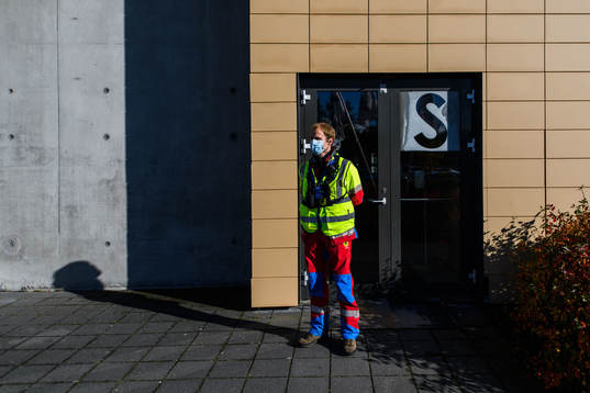 A steward outside Laugardalsvöllur stadium with a face
