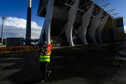 A steward outside Laugardalsvöllur stadium with a face