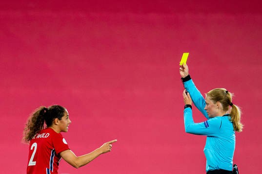 Ingrid Moe Wold of Norway receives a yellow card of referee