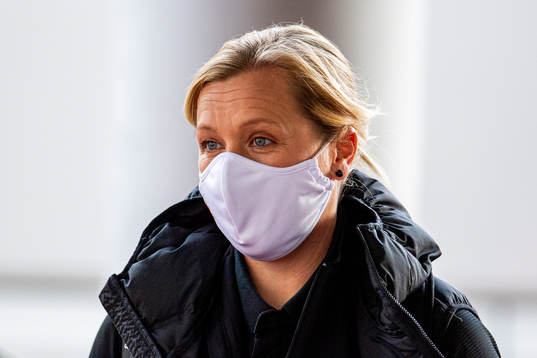 Jayne Ludlow, head coach of Wales, arrives wearing a face