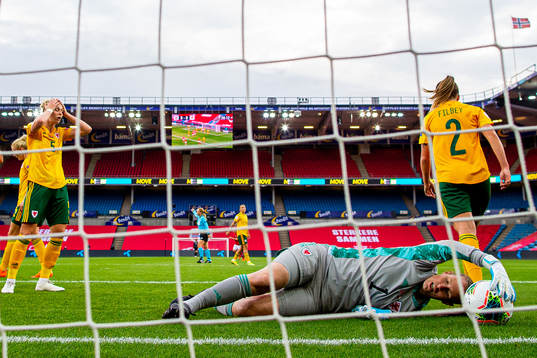Rhiannon Roberts and goalkeeper Laura O'Sullivan of Wales