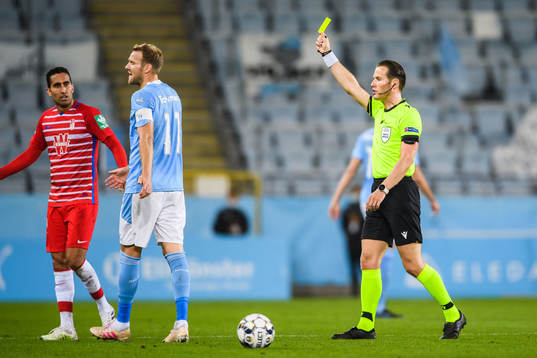 Ola Toivonen of Malmö FF receives a warning from referee