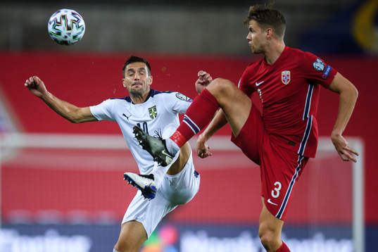 Dusan Tadic of Serbia and Kristoffer Ajer of Norway