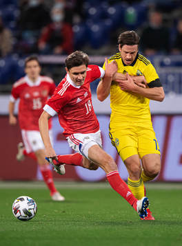 Yuri Zhirkov of Russia in action against Gustav Svensson of