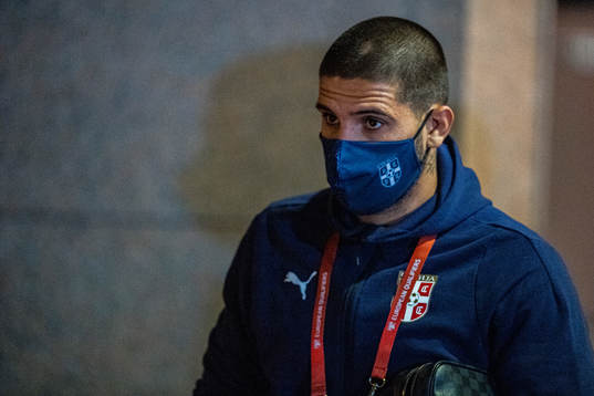 Aleksandar Mitrović of Serbia arrives wearing a face mask