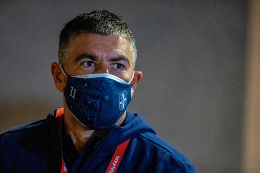 Aleksandar Kolarov of Serbia arrives wearing a face mask