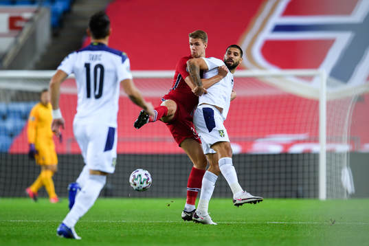Kristoffer Ajer of Norway and Aleksandar Mitrovic of Serbia