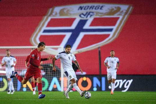 Sander Berge of Norway and Aleksandar Mitrovic of Serbia