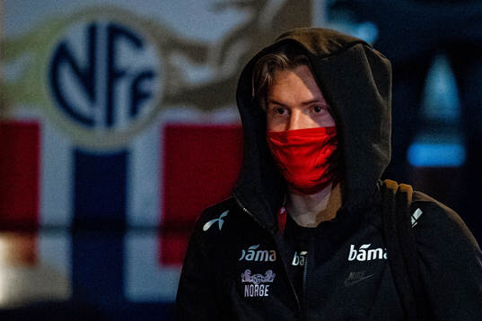 Jens Petter Hauge of Norway arrives wearing a face mask