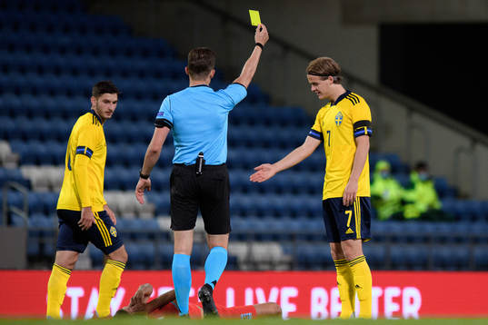 August Erlingmark of Sweden receives a yellow card