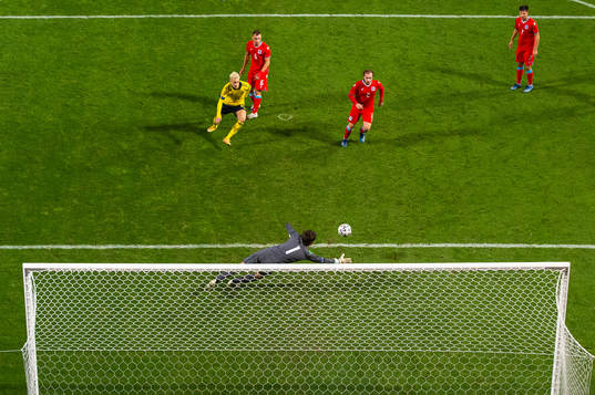 Pontus Almqvist of Sweden sees goalkeeper Tom Ottele of