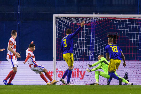 Goalkeeper Robin Olsen of Sweden lets in the 1-0 goal that