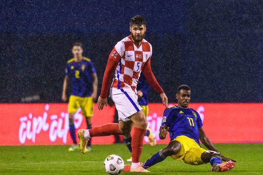 Duje Caleta-Car of Croatia and Alexander Isak of Sweden