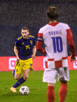 Dejan Kulusevski of Sweden and Luka Modric of Croatia