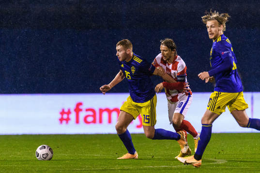Dejan Kulusevski of Sweden and Luka Modric of Croatia