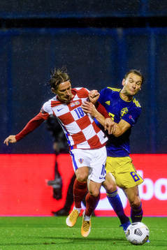 Luka Modric of Croatia fights for the ball with Albin Ekdal