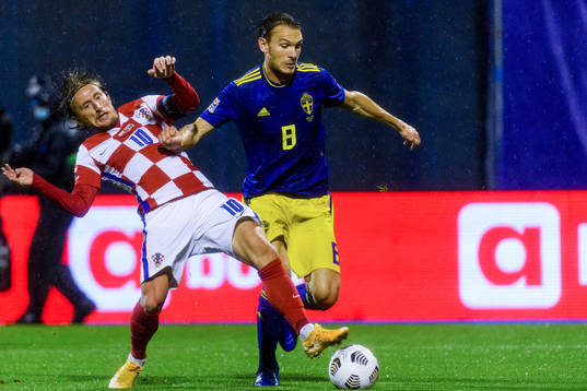 Luka Modric of Croatia fights for the ball with Albin Ekdal