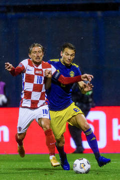 Luka Modric of Croatia fights for the ball with Albin Ekdal