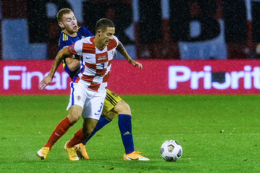 Dejan Kulusevski of Sweden and Domagoj Bradaric of Croatia