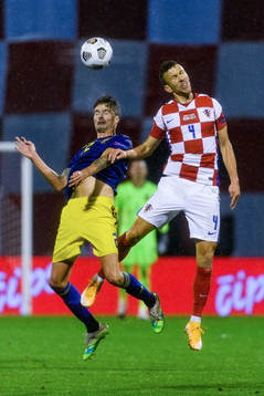 Mikael Lustig of Sweden fights for the ball with Ivan