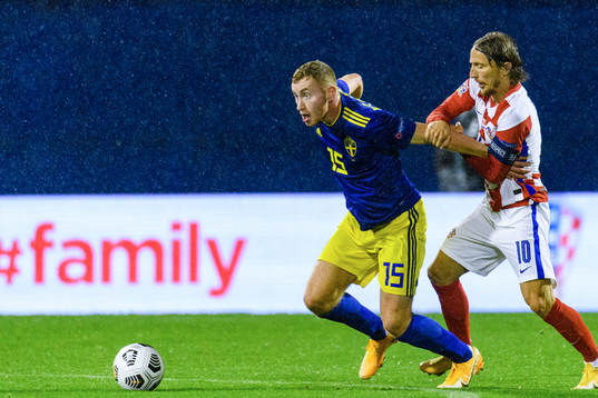 Dejan Kulusevski of Sweden and Luka Modric of Croatia