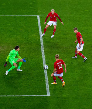 Martin Ødegaard of Norway assists teammate Erling Braut