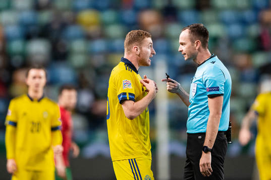 Dejan Kulusevski of Sweden and referee Luis Medina Cantalejo