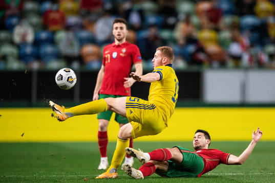 Dejan Kulusevski of Sweden and Raphael Guerreiro of Portugal
