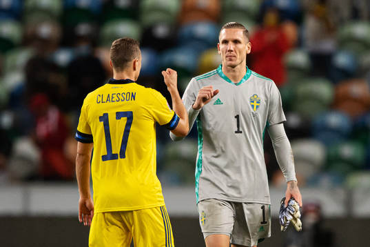Viktor Claesson and goalkeeper Robin Olsen of Sweden