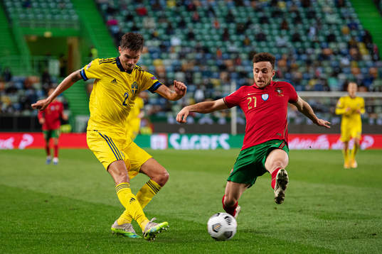 Mikael Lustig of Sweden and Diogo Jota of Portugal