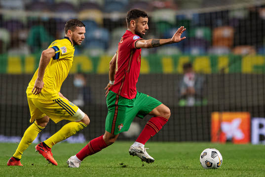 Marcus Berg of Sweden and Bruno Fernandes of Portugal