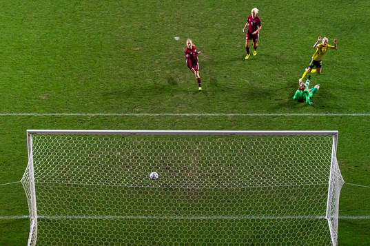 Olivia Schough of Sweden scores 3-0 behind goalkeeper Sofja