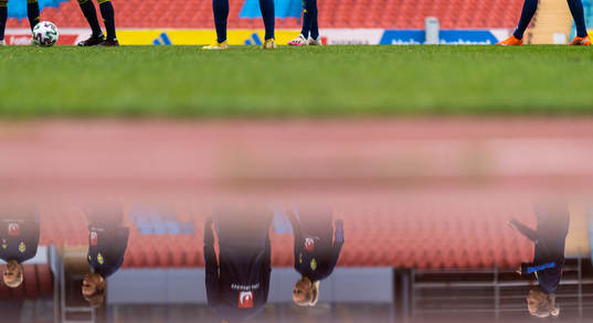 Players reflected in water