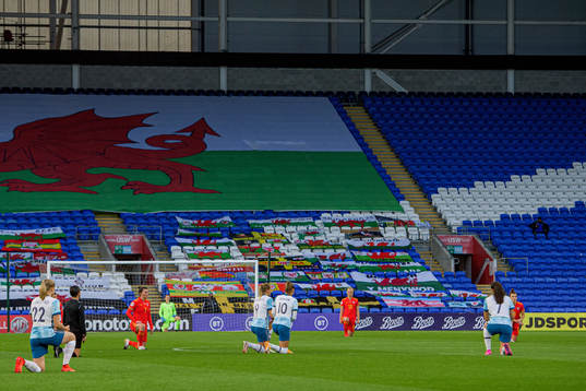 Players of Norway and Wales kneel in support of the "Black