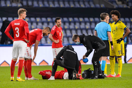 Joakim Mæhle of Denmark receives medical treatment