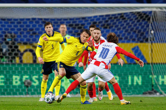 Albin Ekdal of Sweden and Luka Modric of Croatia