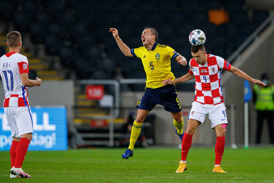 Pierre Bengtsson of Sweden and Ivan Perisic of Croatia
