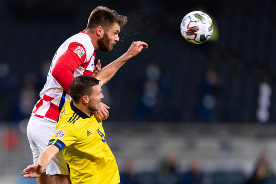 Duje Caleta-Car of Croatia and Marcus Berg of Sweden