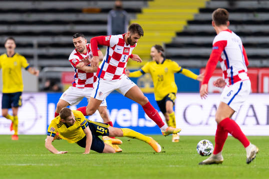 Dejan Kulusevski of Sweden and Duje Caleta-Car of Croatia