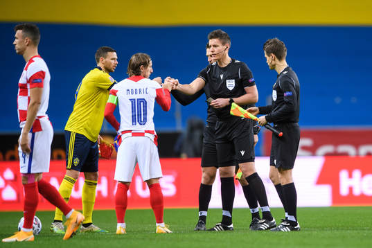 Marcus Berg of Sweden and Luka Modric of Croatia