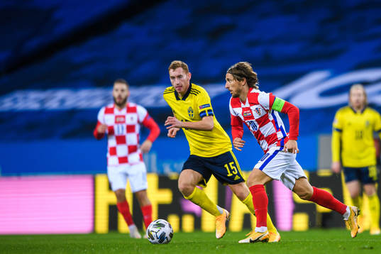 Dejan Kulusevski of Sweden and Luka Modric of Croatia
