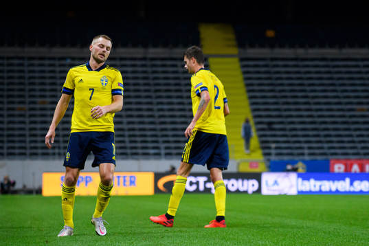 Sebastian Larsson and Mikael Lustig of Sweden look dejected