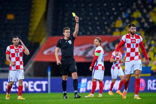 Duje Caleta-Car of Croatia receives a yellow card from