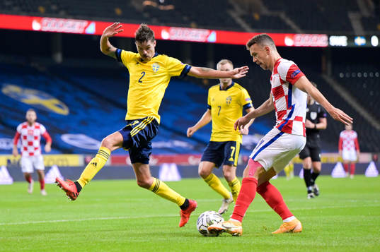 Mikael Lustig of Sweden and Ivan Perisic of Croatia